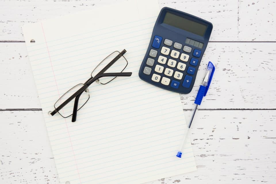 Minimalist desk with a calculator and paperwork